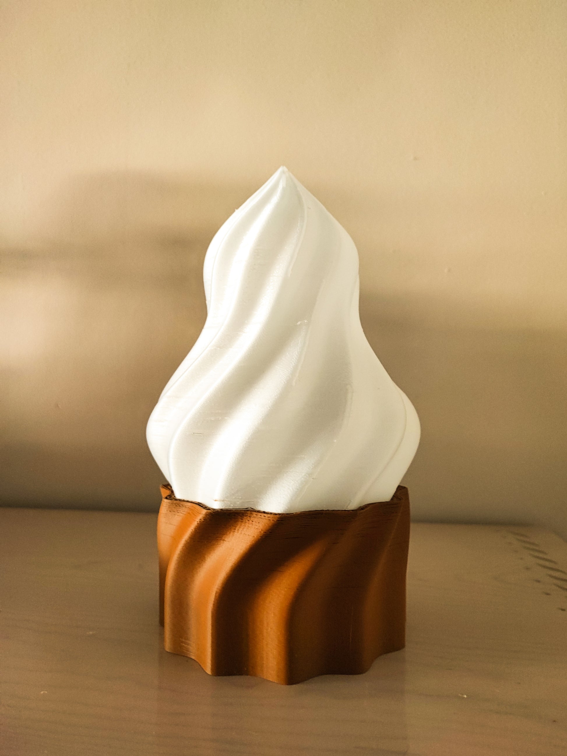 a brown and white sculpture sitting on top of a wooden table