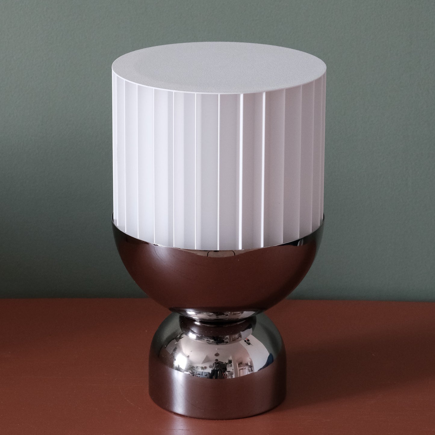 a white and brown lamp sitting on top of a table