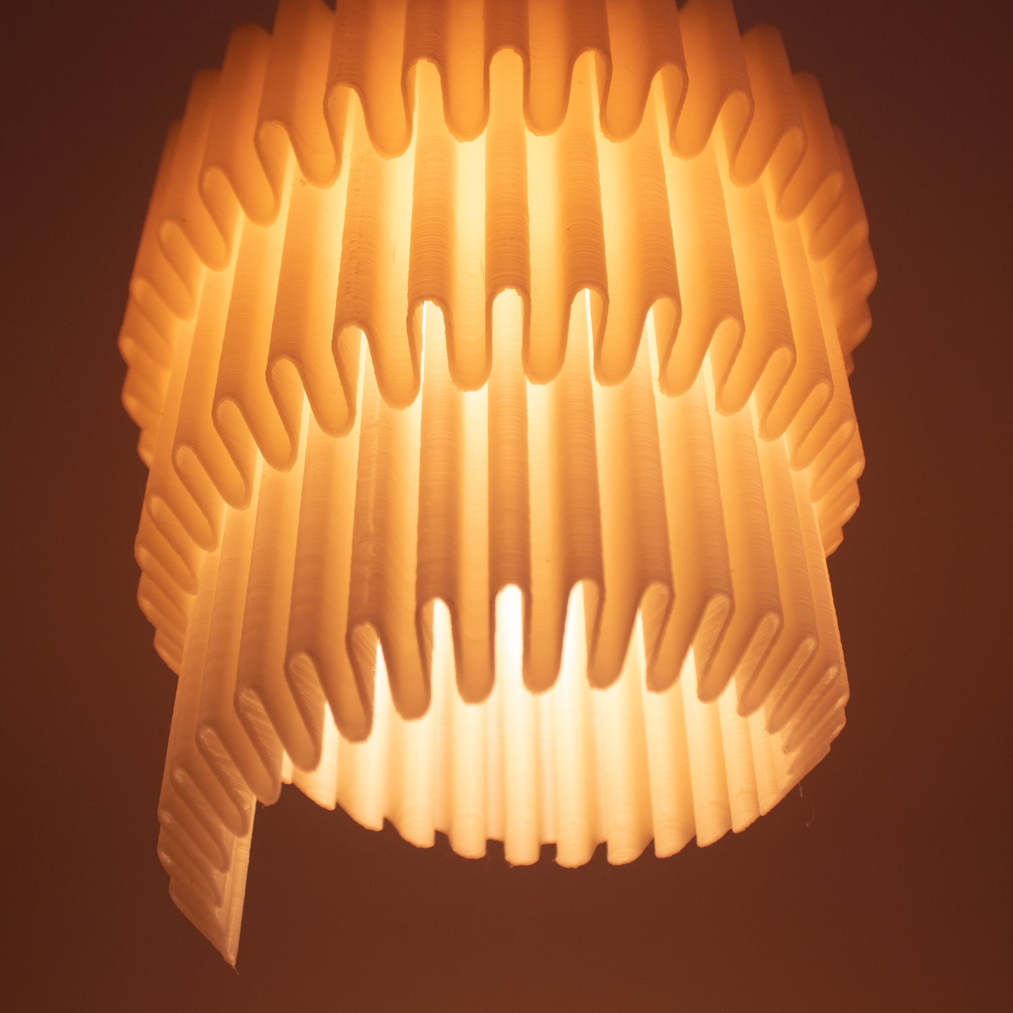 a close up of a light fixture with a brown background