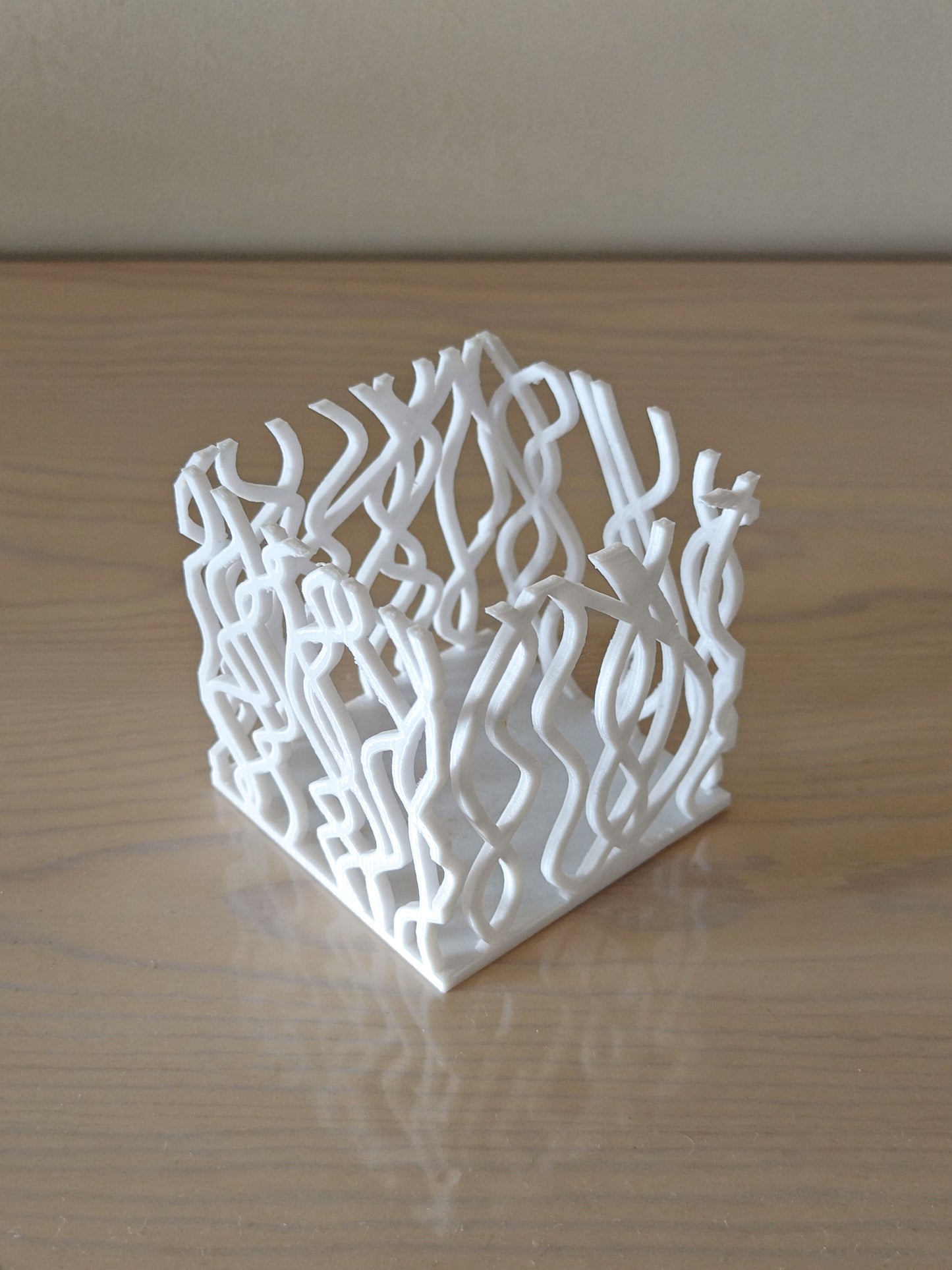 a white sculpture sitting on top of a wooden table