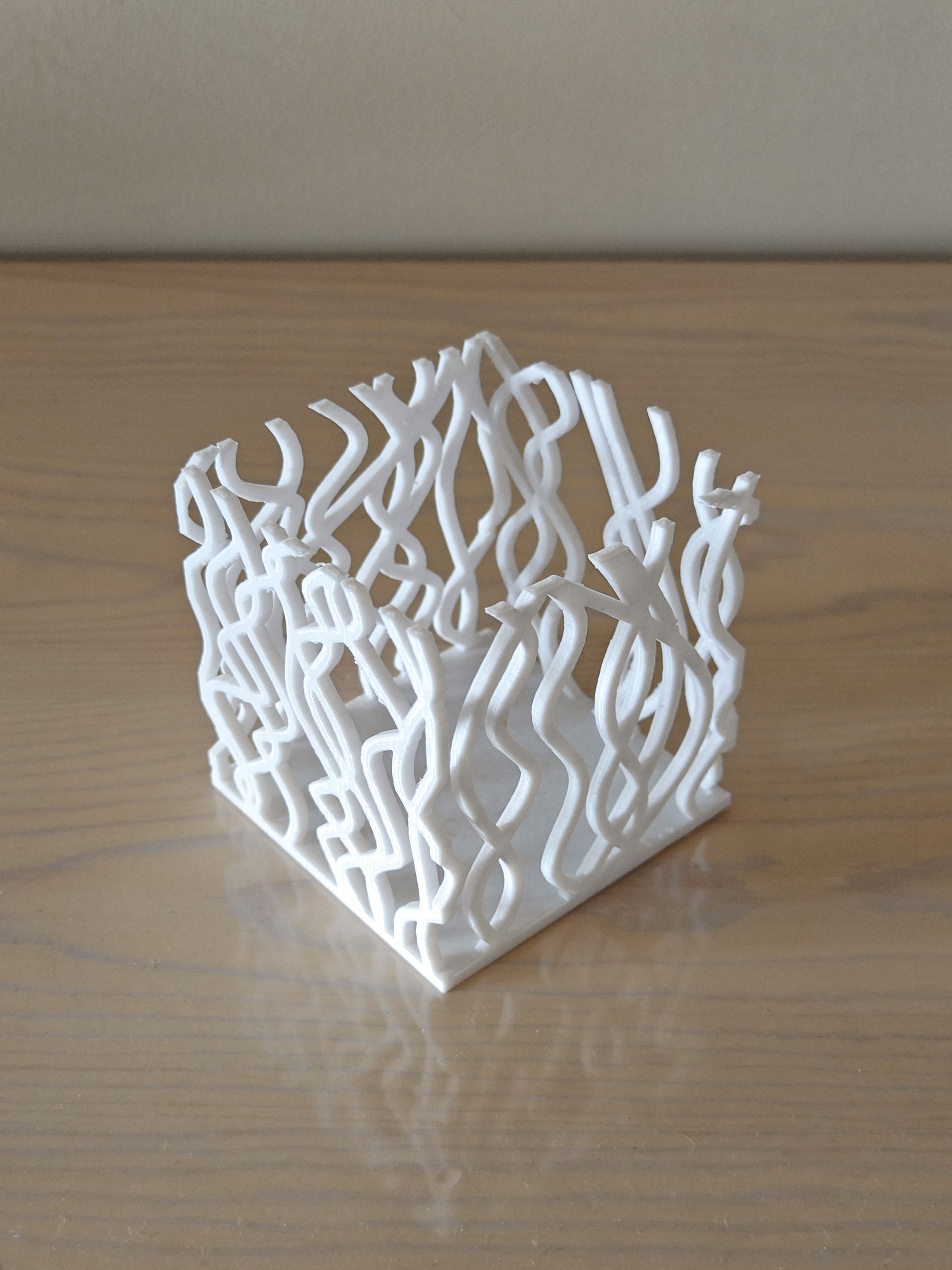 a white sculpture sitting on top of a wooden table