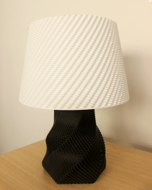 a black and white lamp on a wooden table