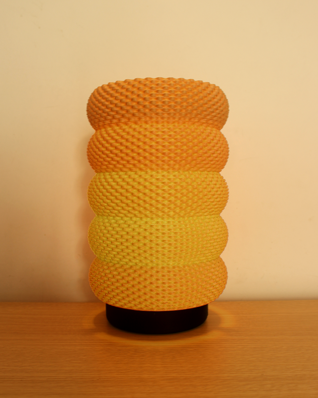 a yellow vase sitting on top of a wooden table
