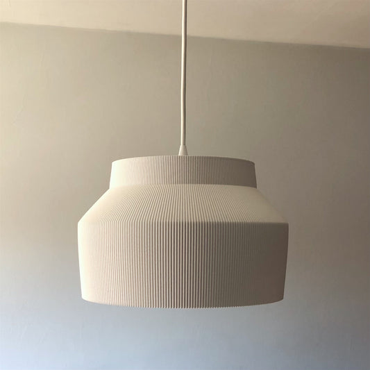 a white lamp hanging from a ceiling in a room