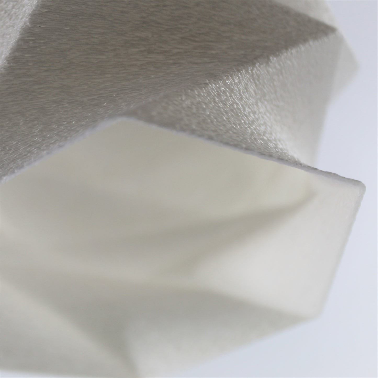 a close up of a white object with a white background