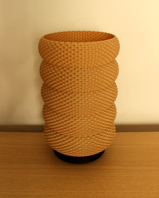 a brown vase sitting on top of a wooden table