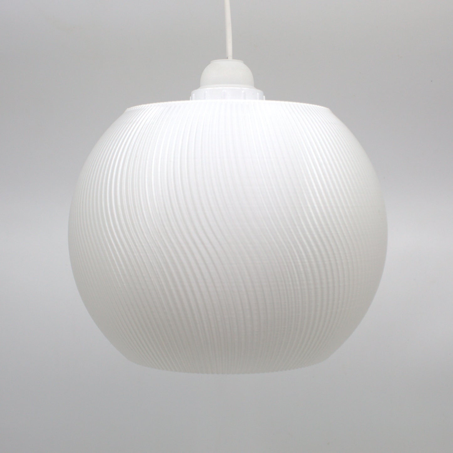 a white light hanging from a ceiling in a room