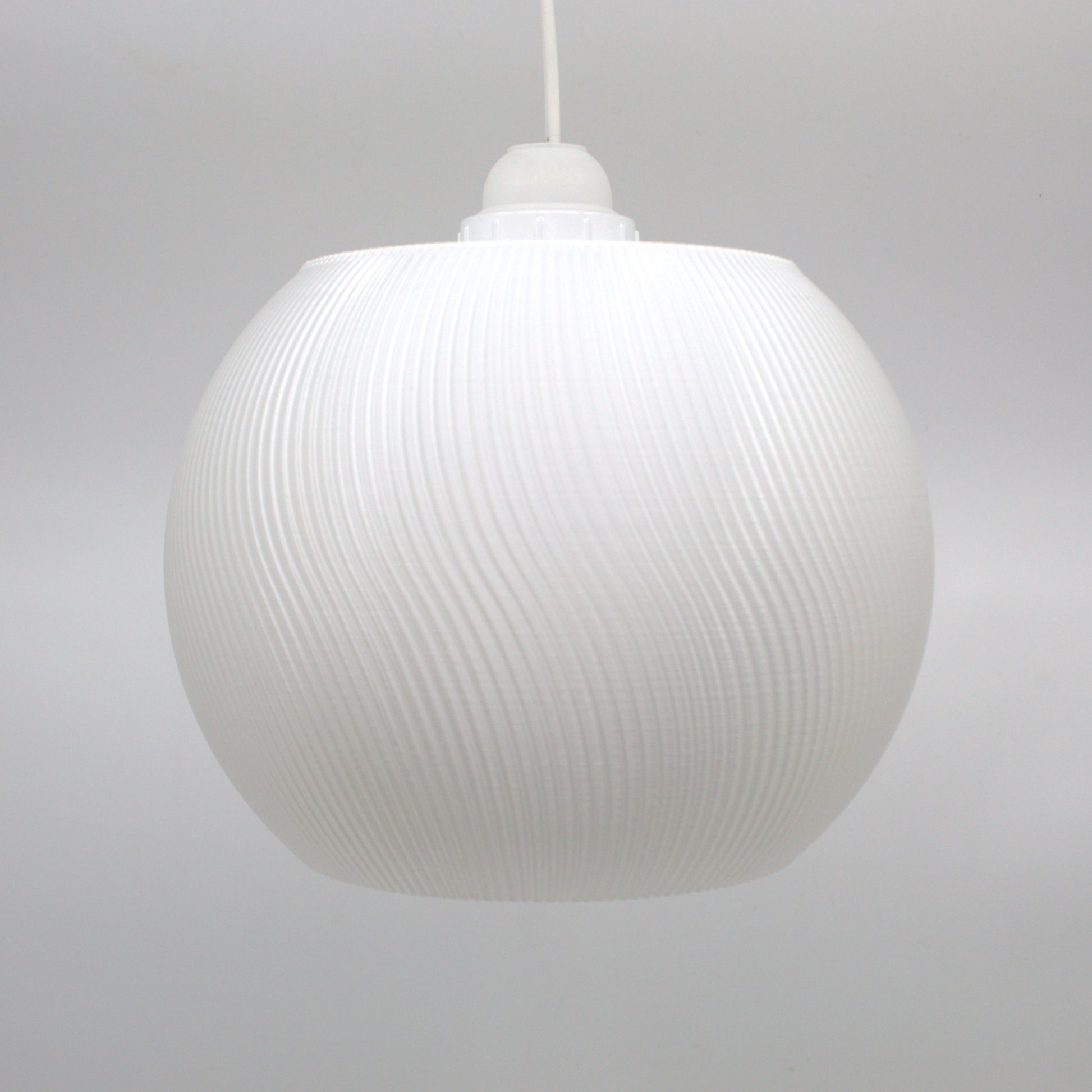 a white light hanging from a ceiling in a room