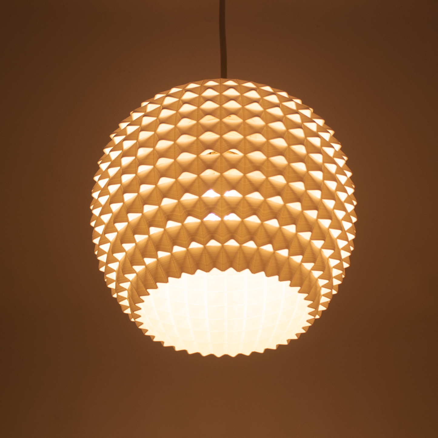a light hanging from a ceiling in a room
