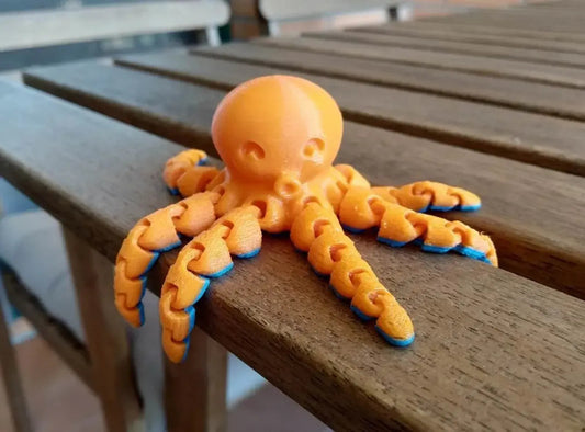 a toy octopus sitting on top of a wooden bench