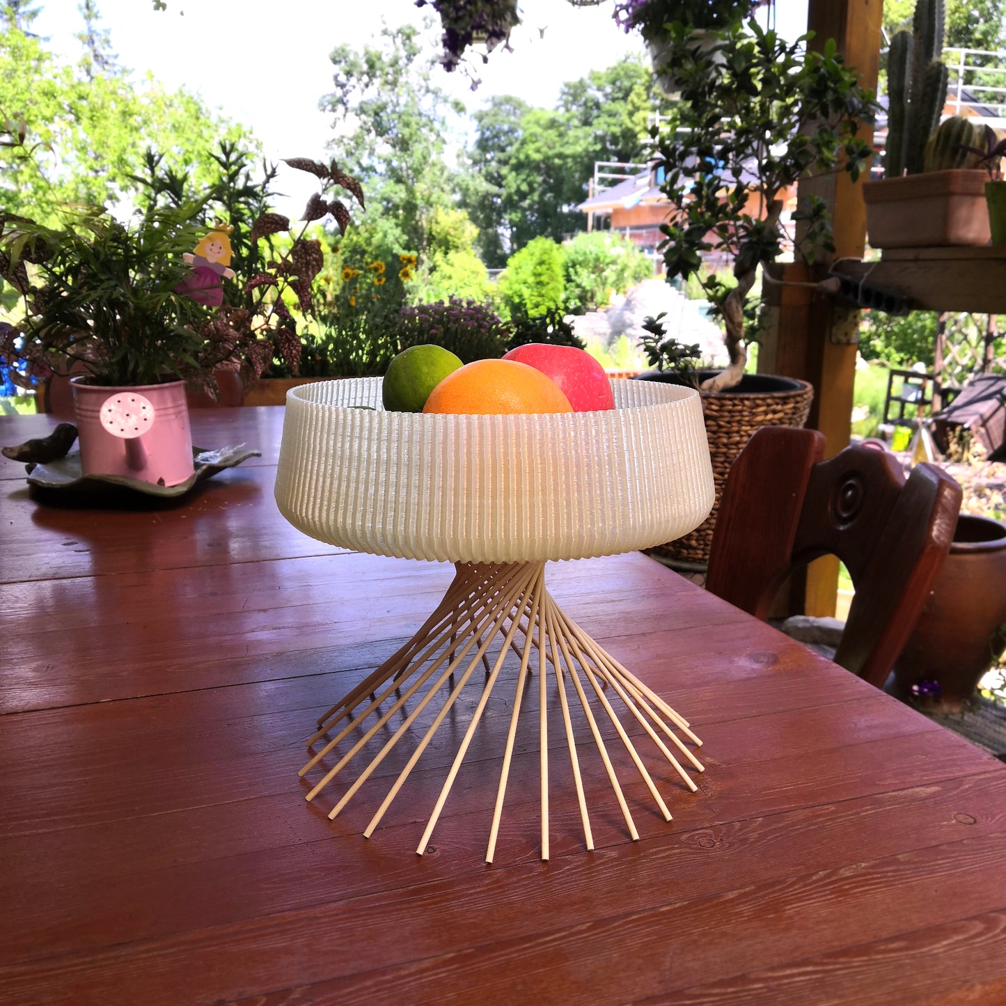 a bowl of fruit sitting on top of a wooden table