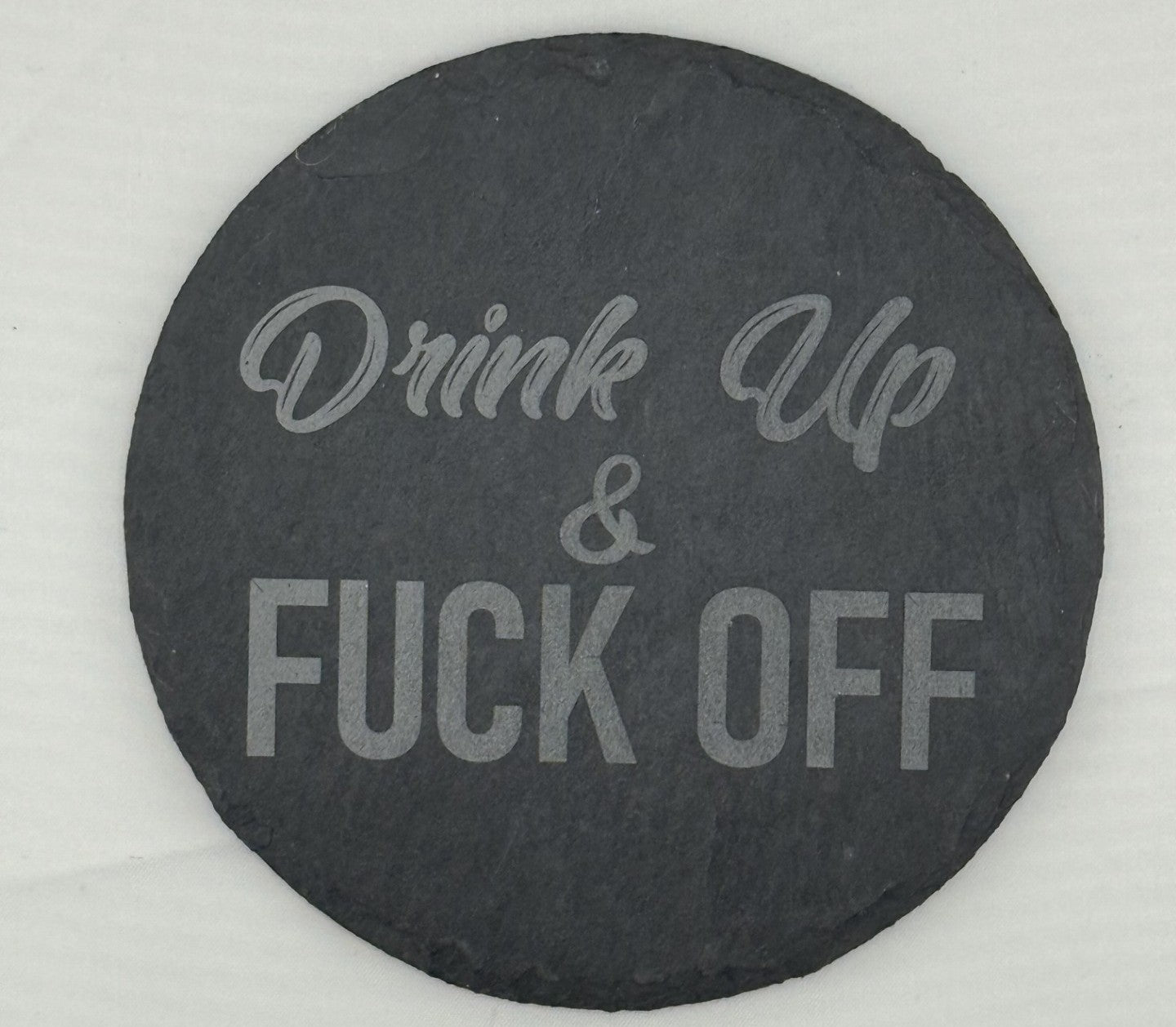 a black stone with the words wine up and a white lettering on it