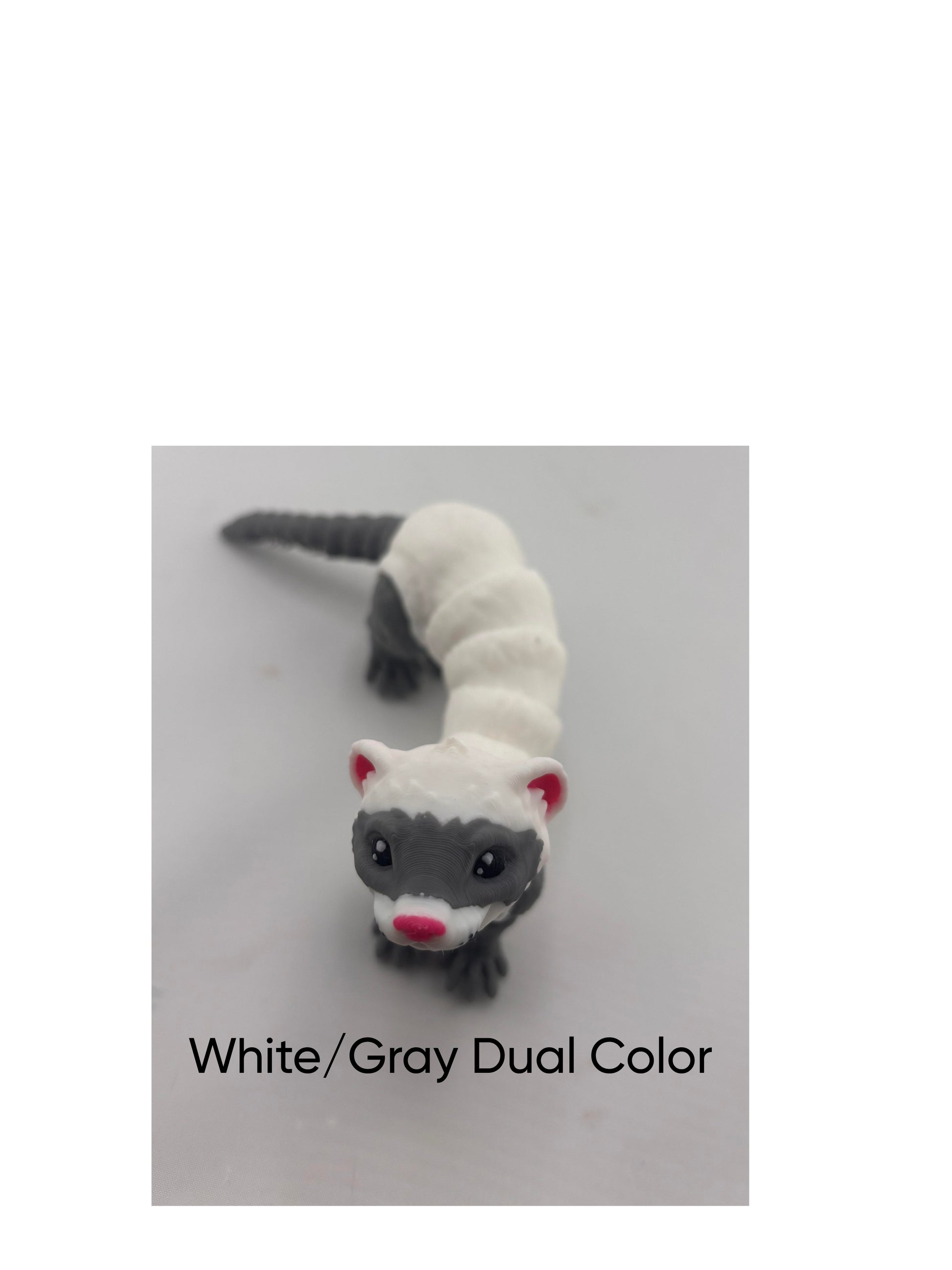 a white and gray stuffed animal on a table