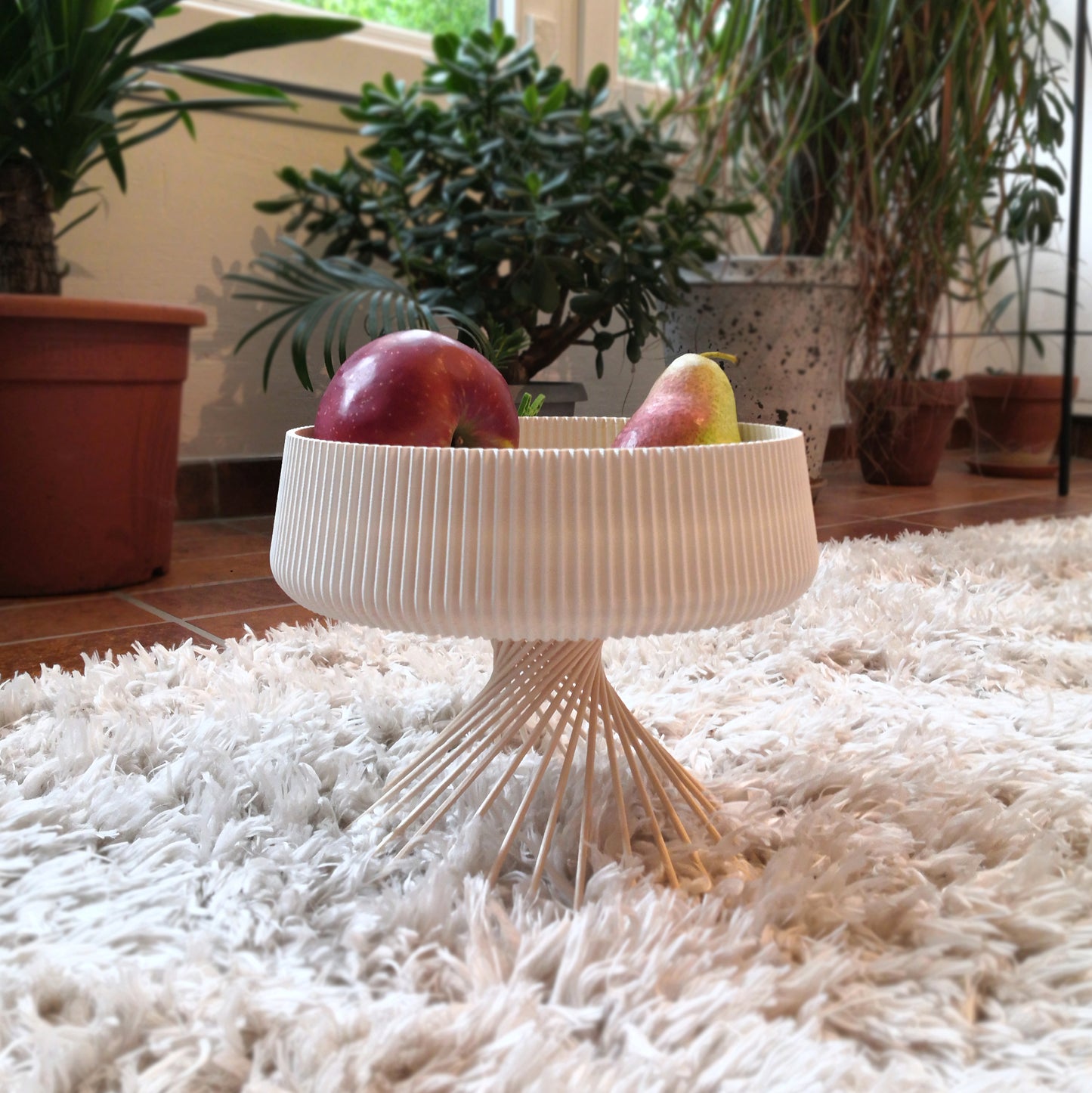 a bowl of fruit sitting on top of a white rug