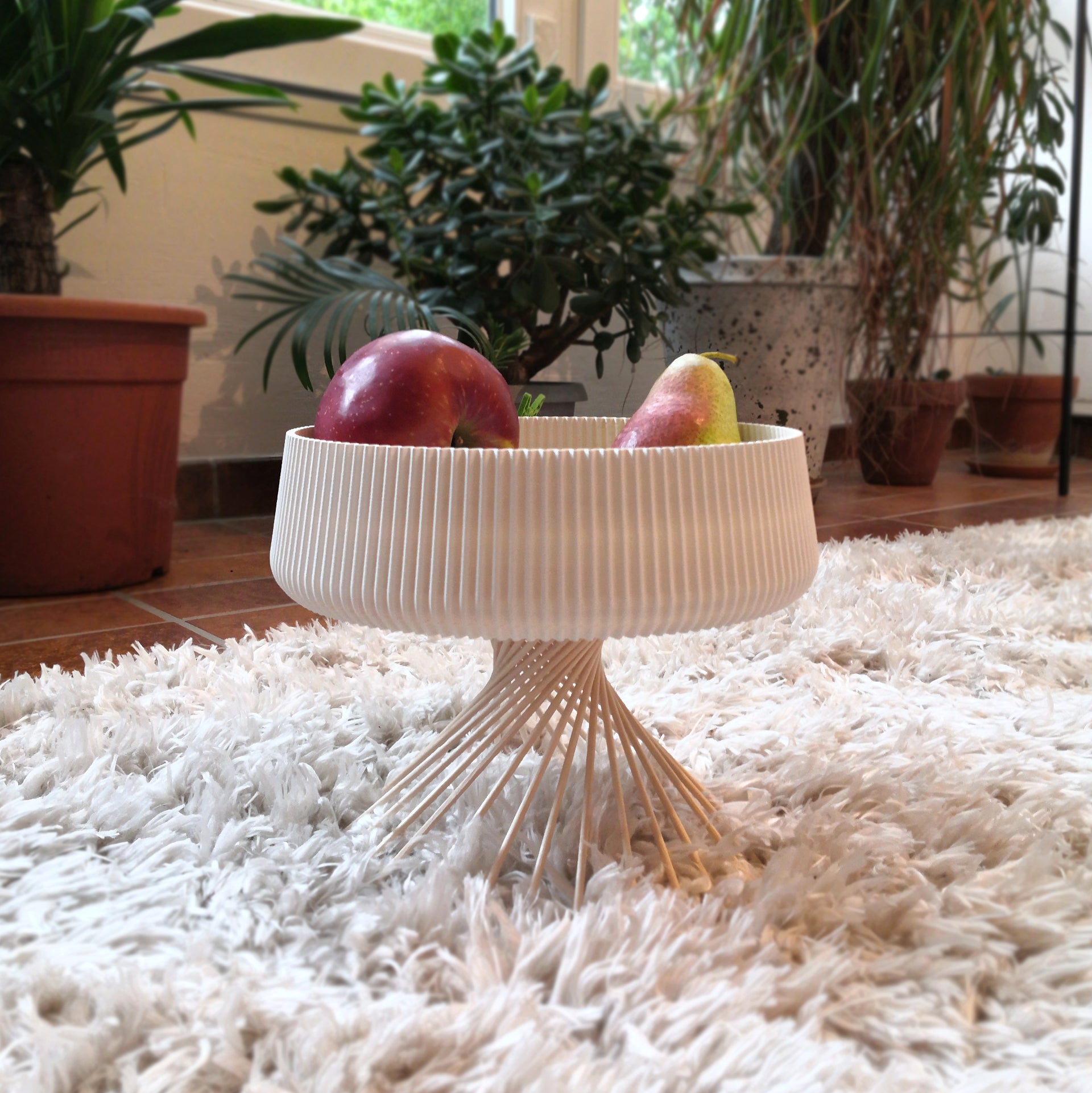 a bowl of fruit sitting on top of a white rug