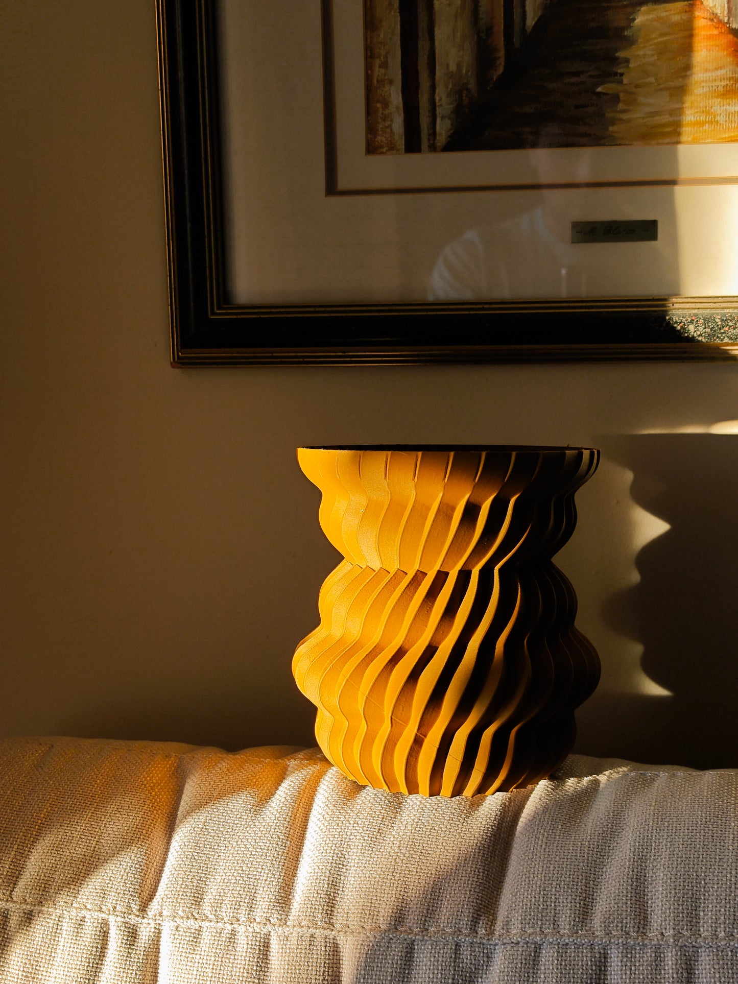 a stack of yellow plates sitting on top of a bed