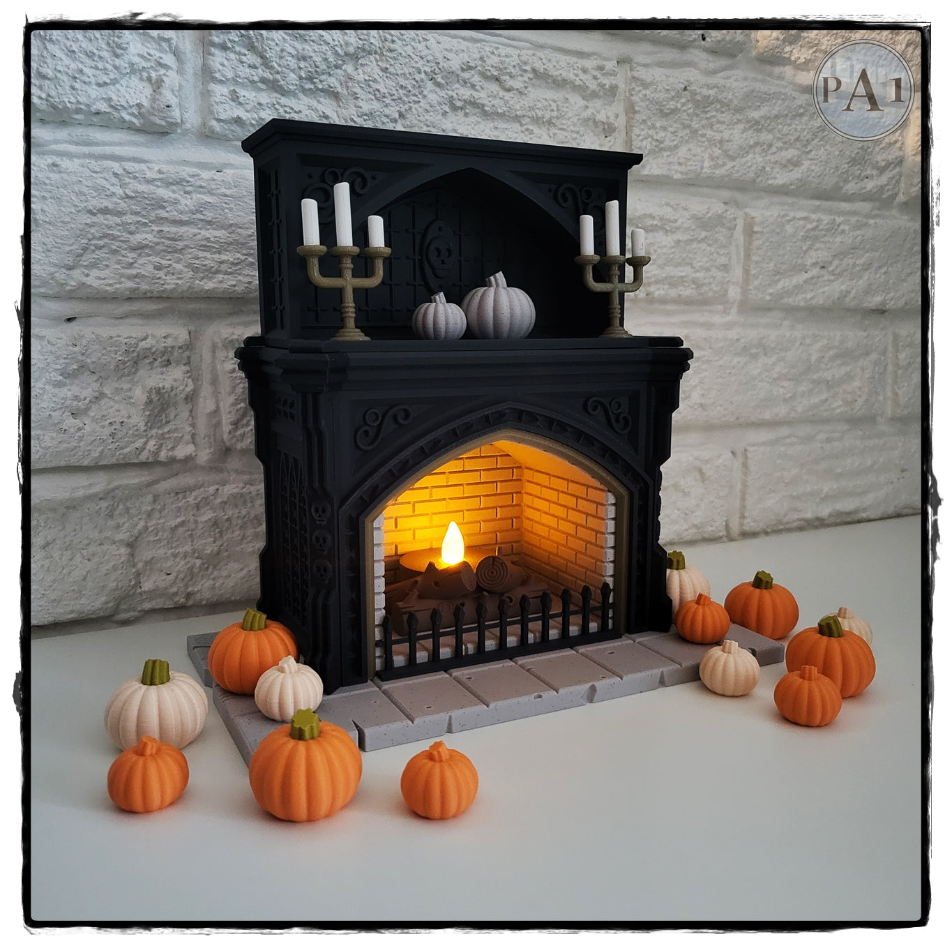 A miniature fireplace with a lit fire, surrounded by a collection of small orange pumpkins, creating a cozy and festive atmosphere.