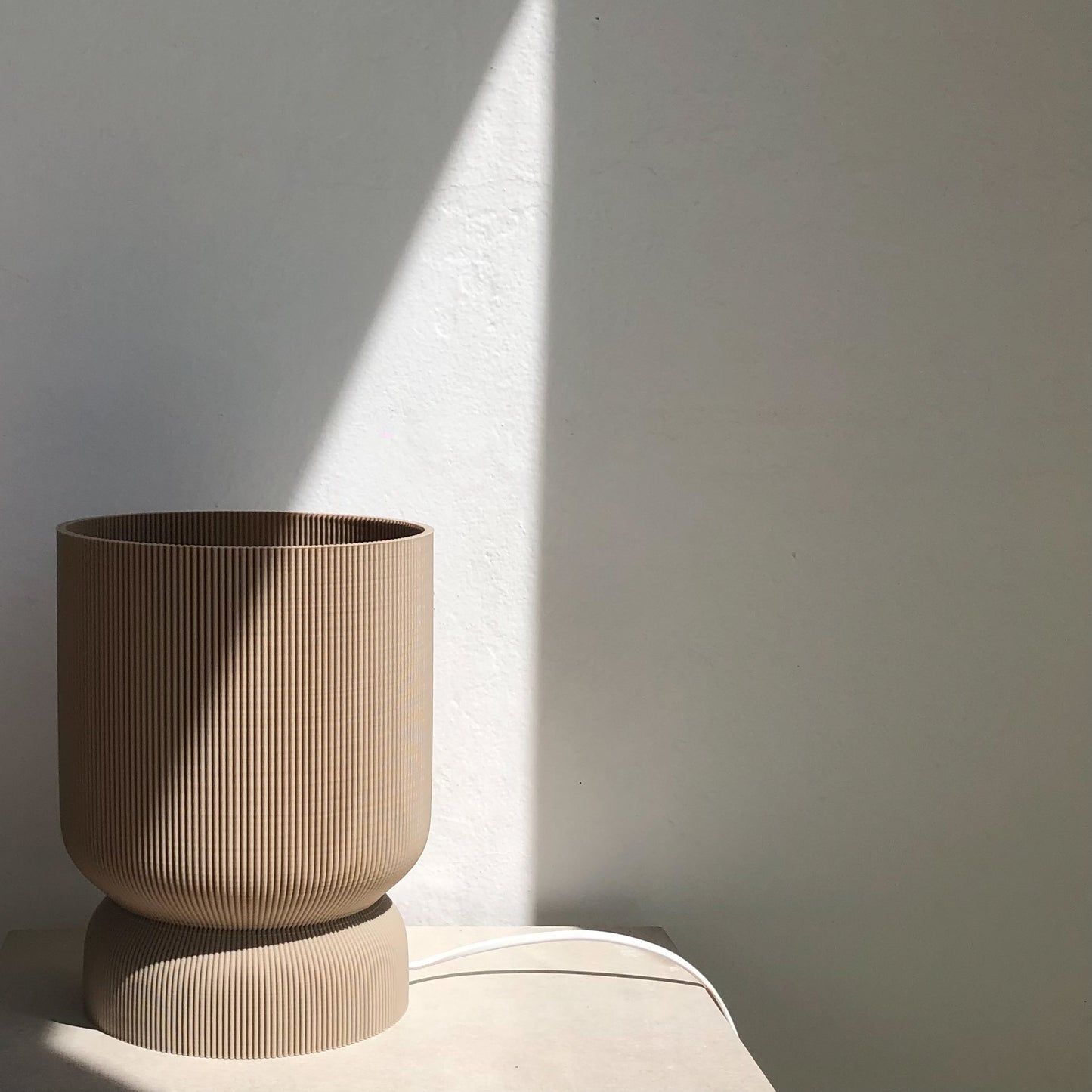 a brown vase sitting on top of a table