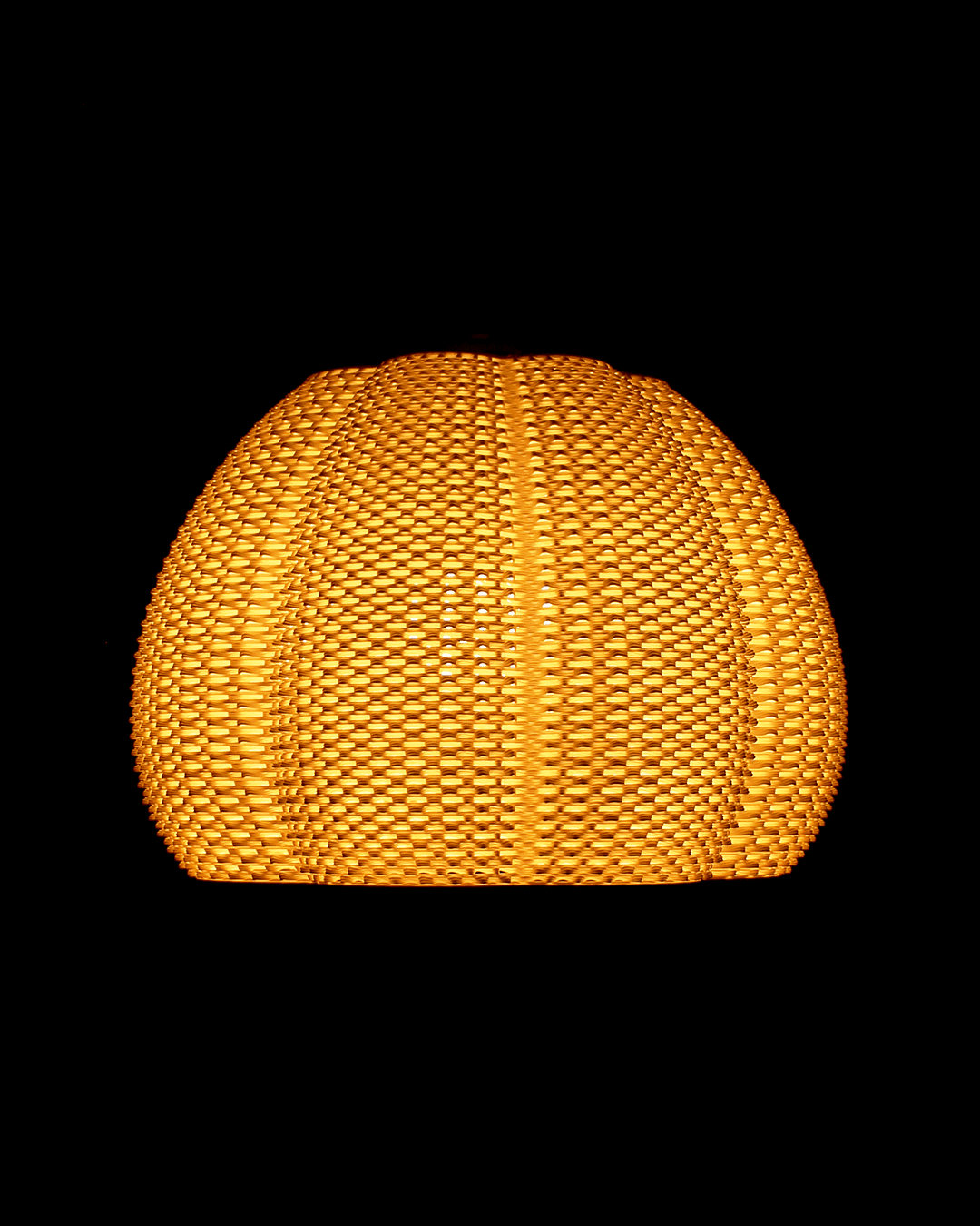 a yellow lamp hanging from a ceiling in a dark room