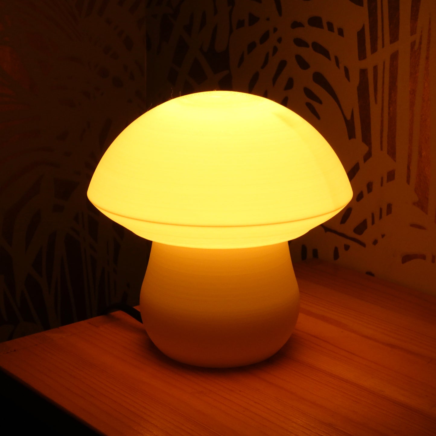 a white lamp sitting on top of a wooden table