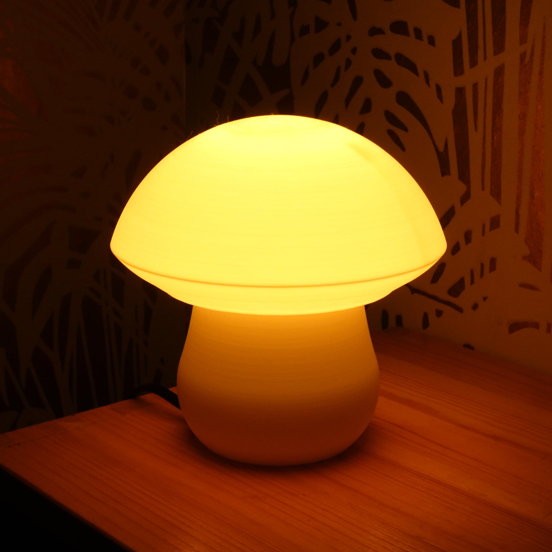a white lamp sitting on top of a wooden table