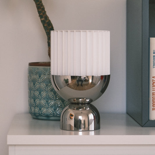 a lamp sitting on top of a white shelf