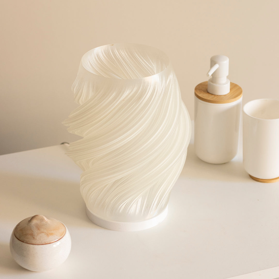 a white vase sitting on top of a white table