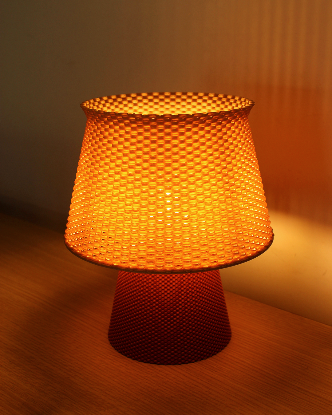 a yellow lamp sitting on top of a wooden table