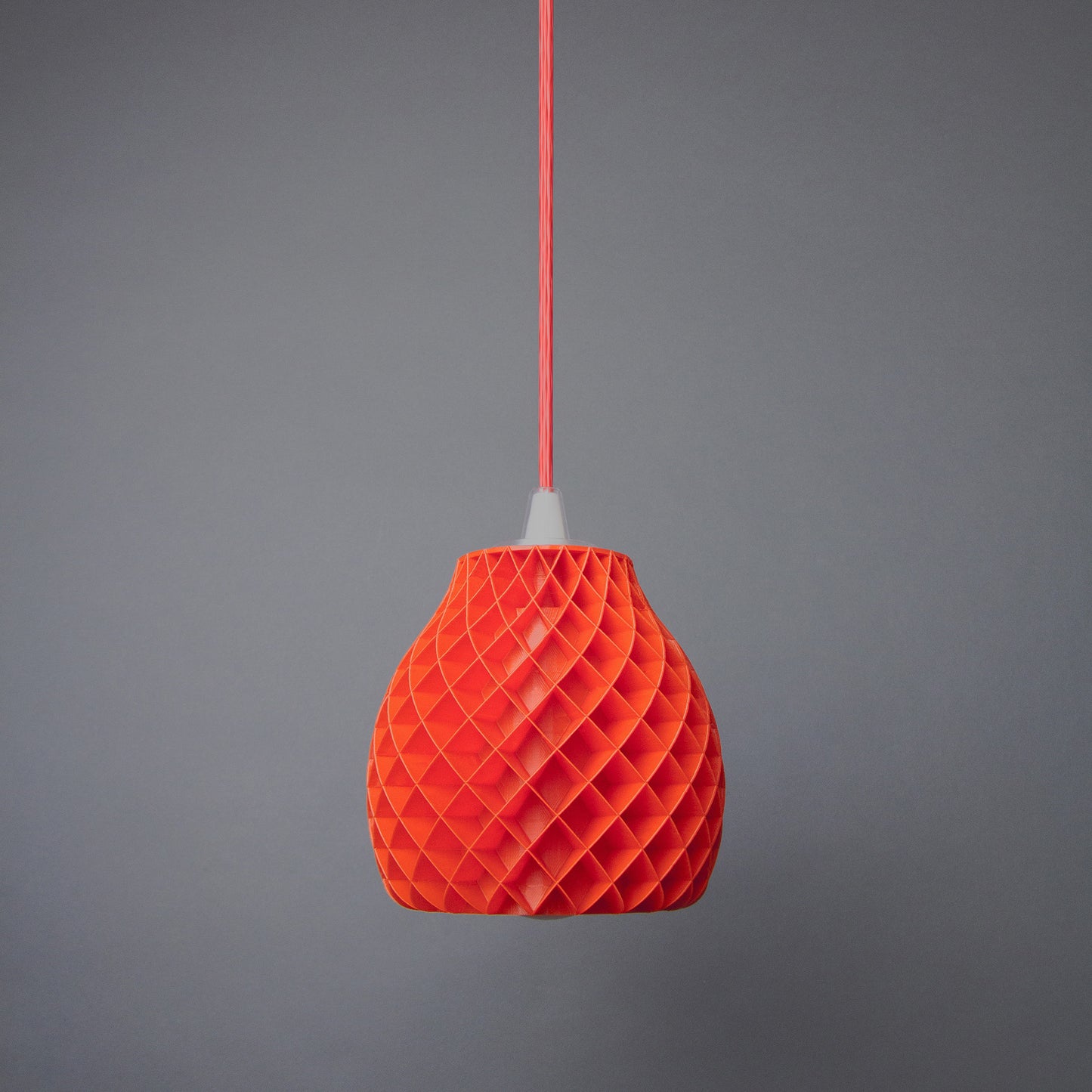 an orange origami light hanging from a string