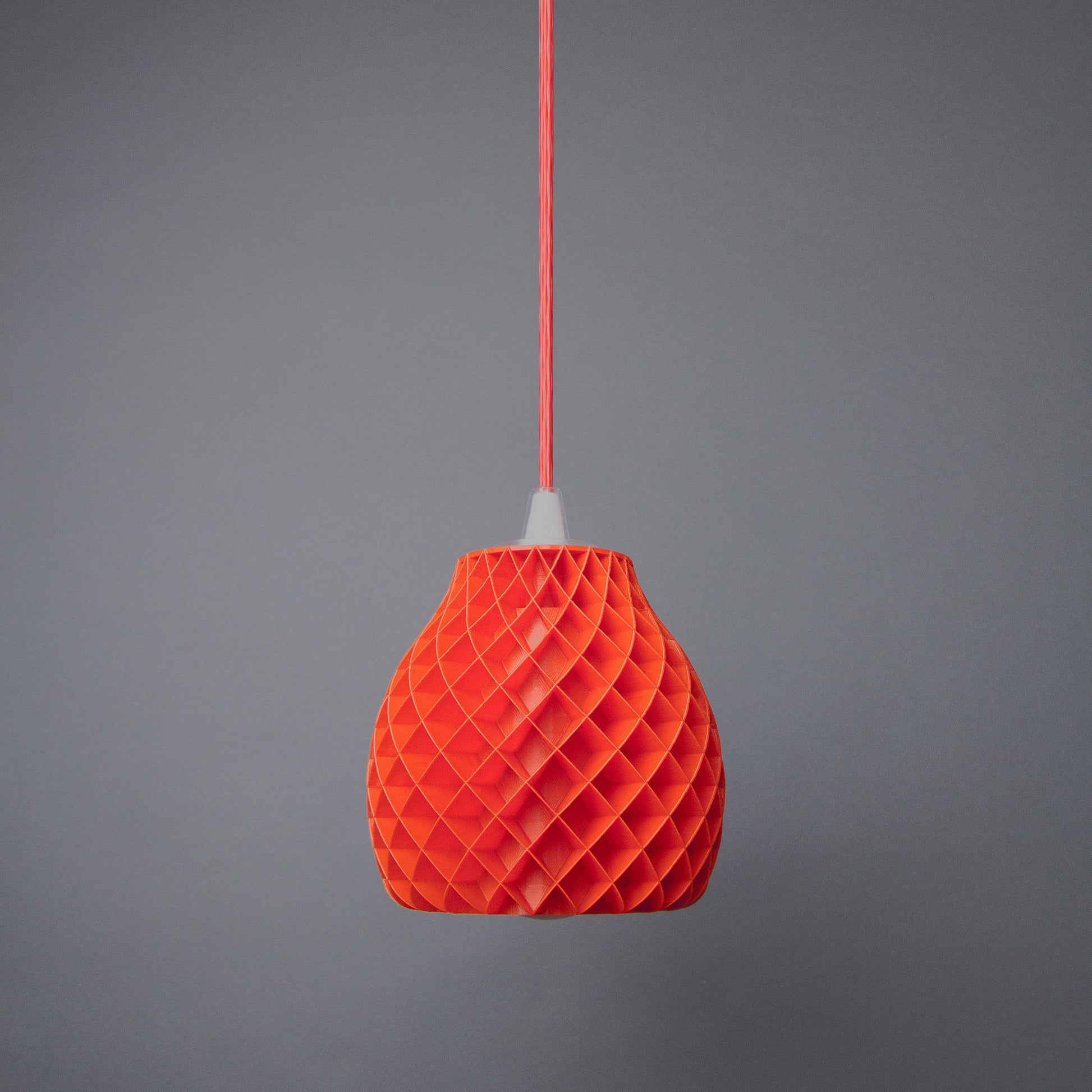 an orange origami light hanging from a string