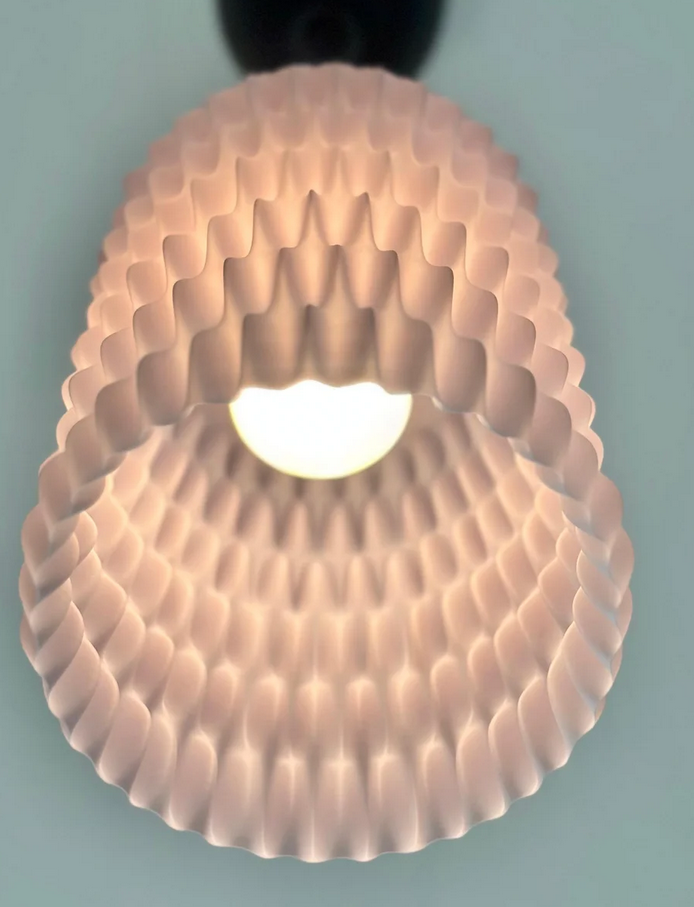 A close-up view of a light fixture with a unique, textured design that creates a warm, glowing effect.