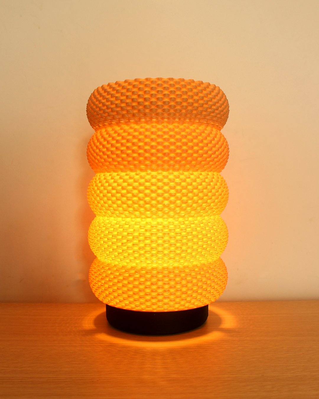 a yellow lamp sitting on top of a wooden table