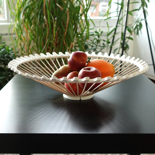 a bowl of fruit is sitting on a table