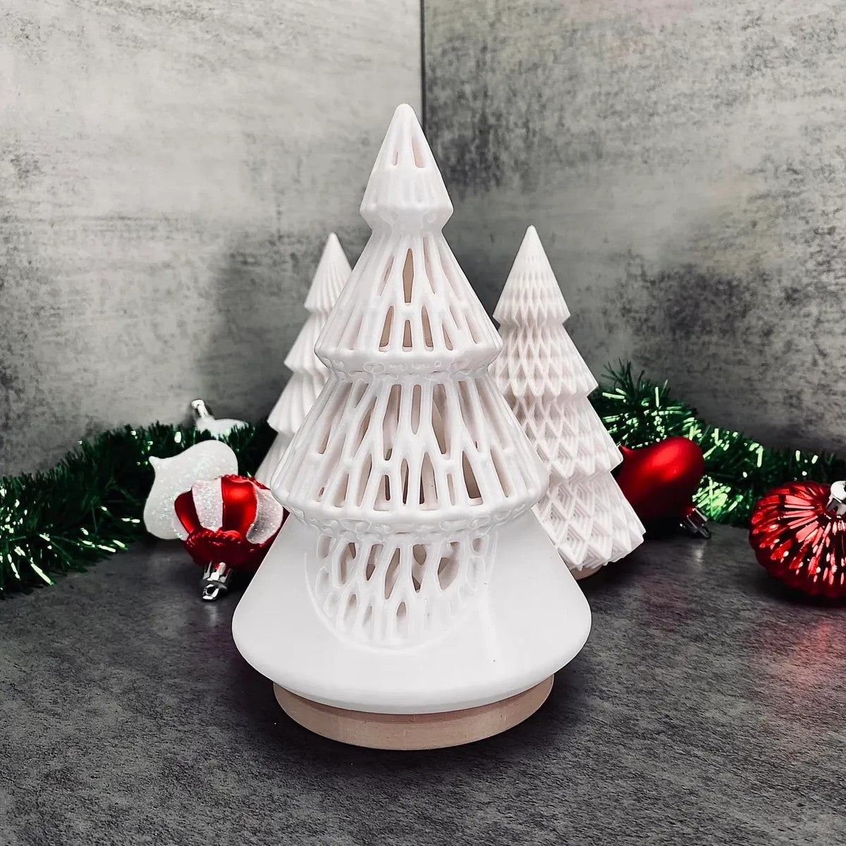 a white christmas tree with ornaments around it