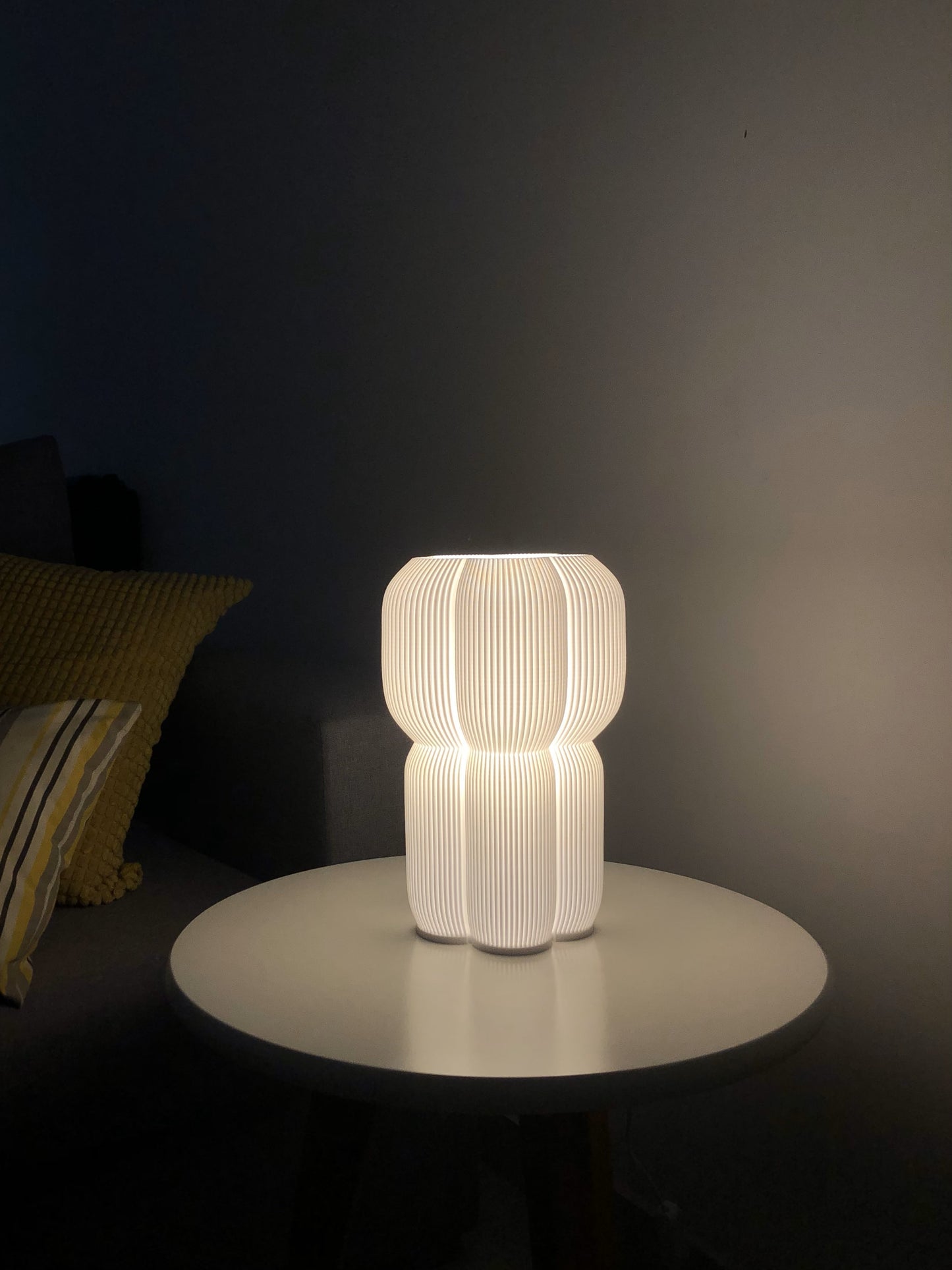 a white lamp sitting on top of a table