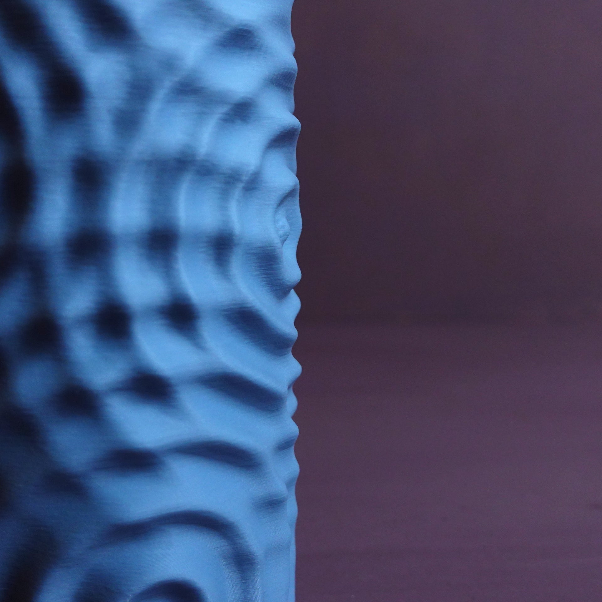 a blue vase sitting on top of a table