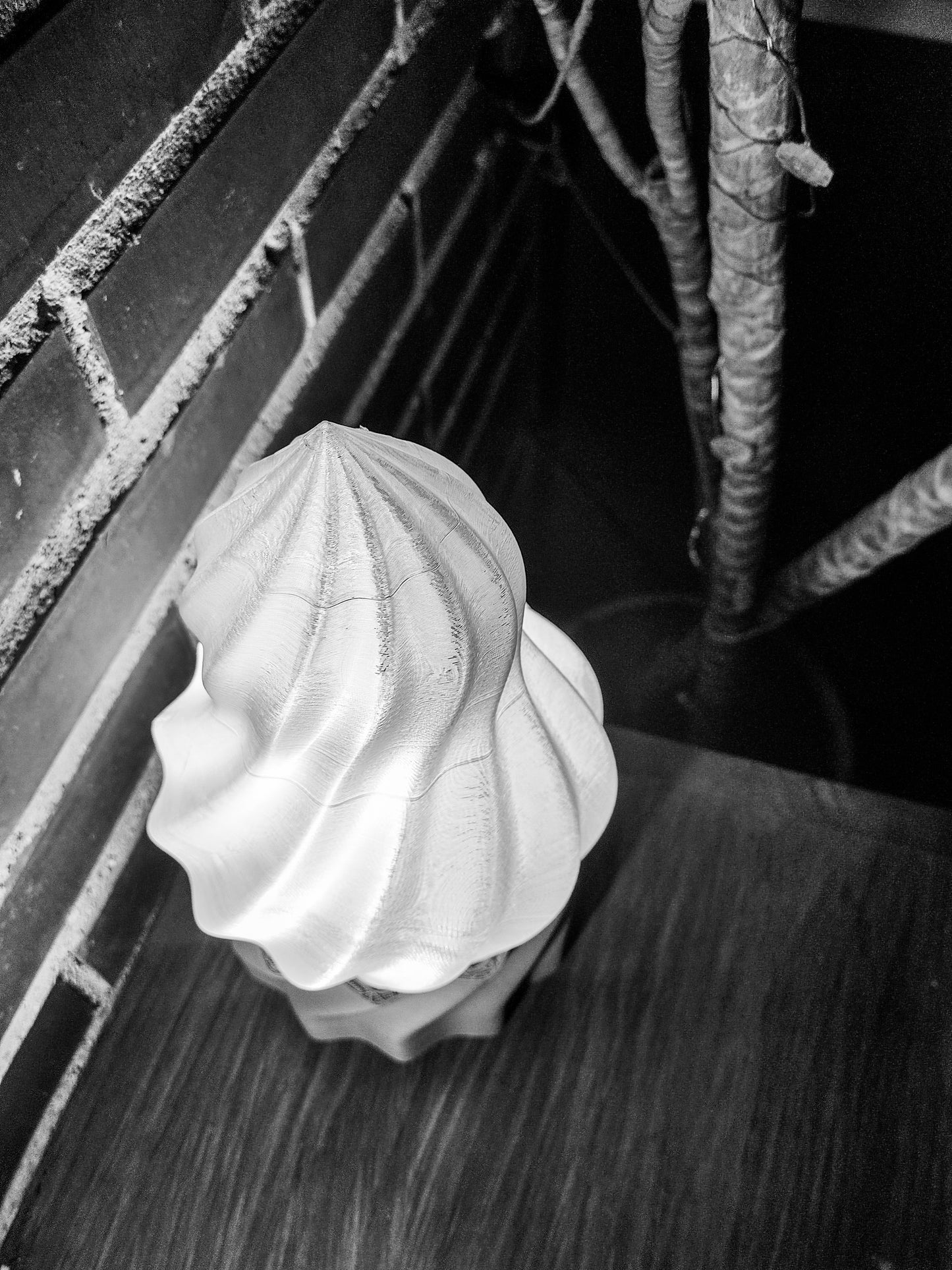 a black and white photo of a hat on a bench