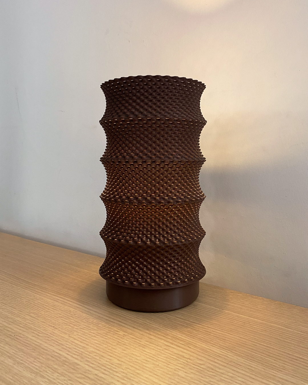 a brown vase sitting on top of a wooden table