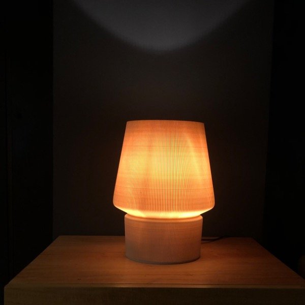 a table lamp sitting on top of a wooden table