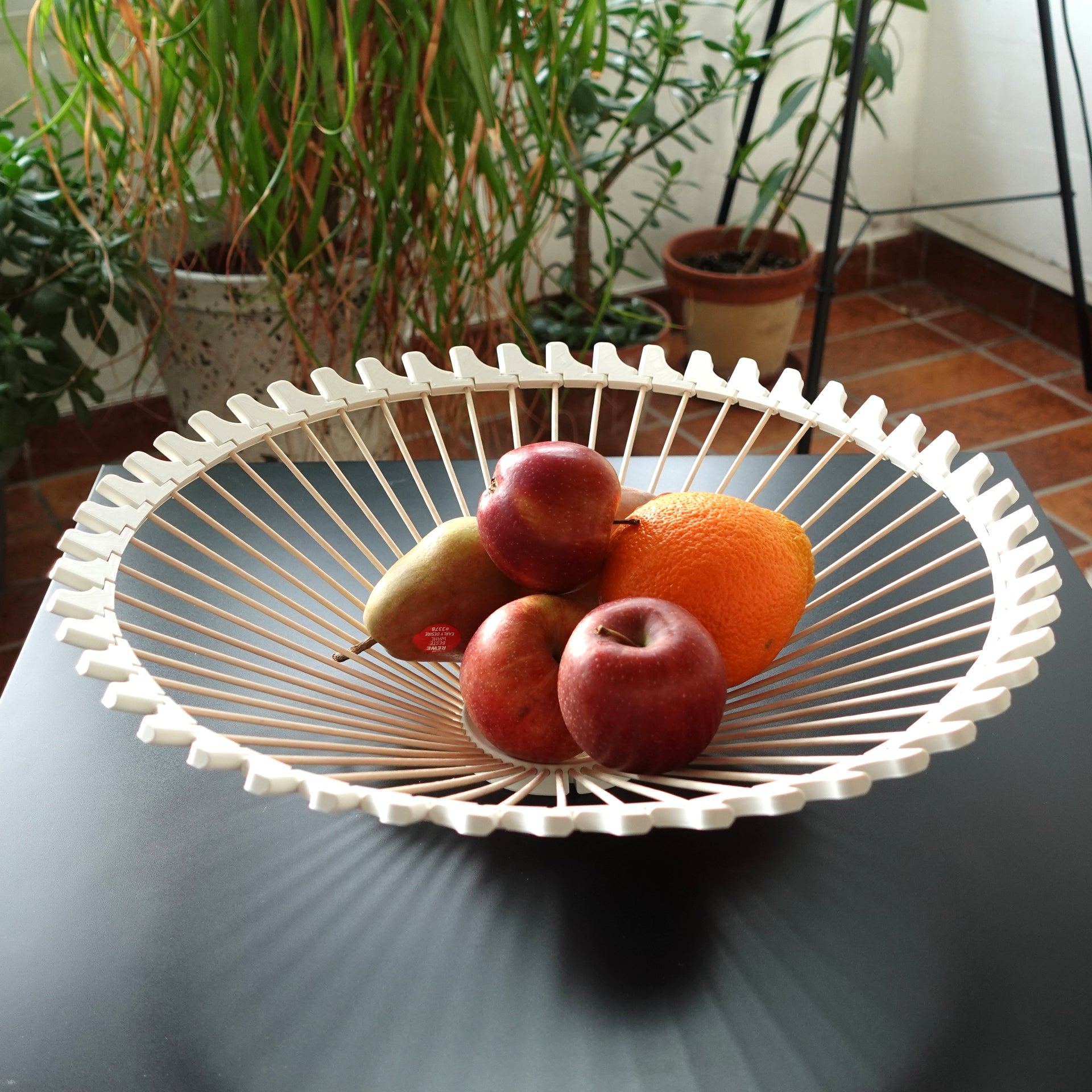 a white bowl filled with fruit on top of a table