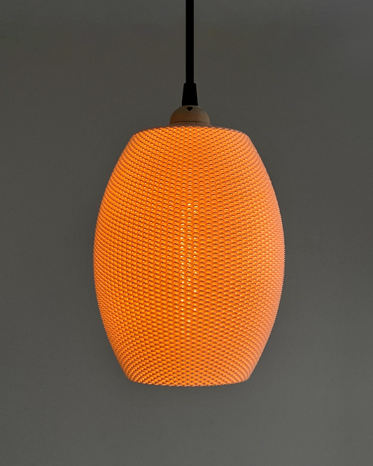 a large orange light hanging from a ceiling