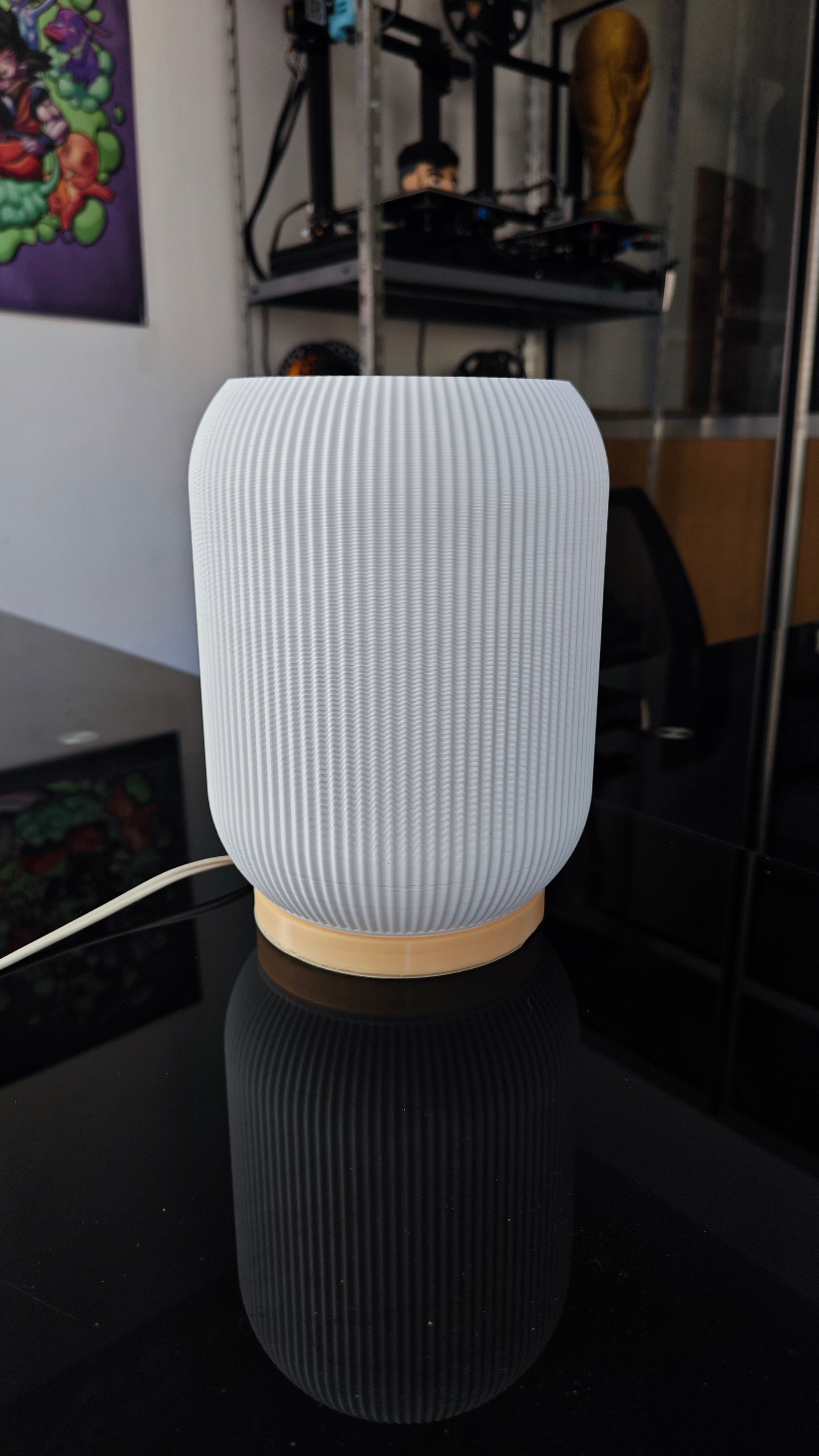 a white vase sitting on top of a black table