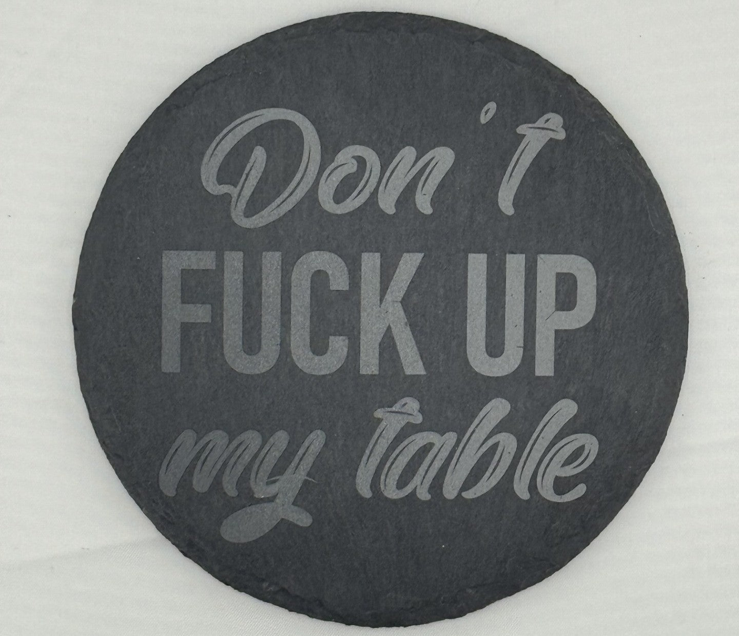a black and white sign that says don't fuck up my table