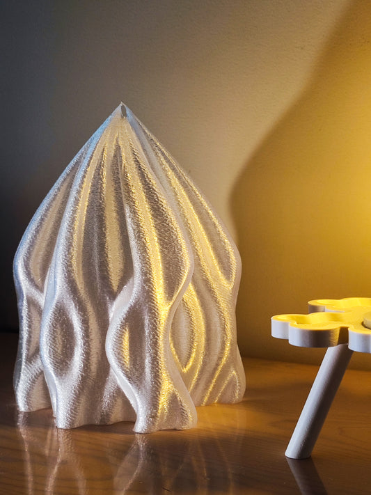 a white sculpture sitting on top of a wooden table