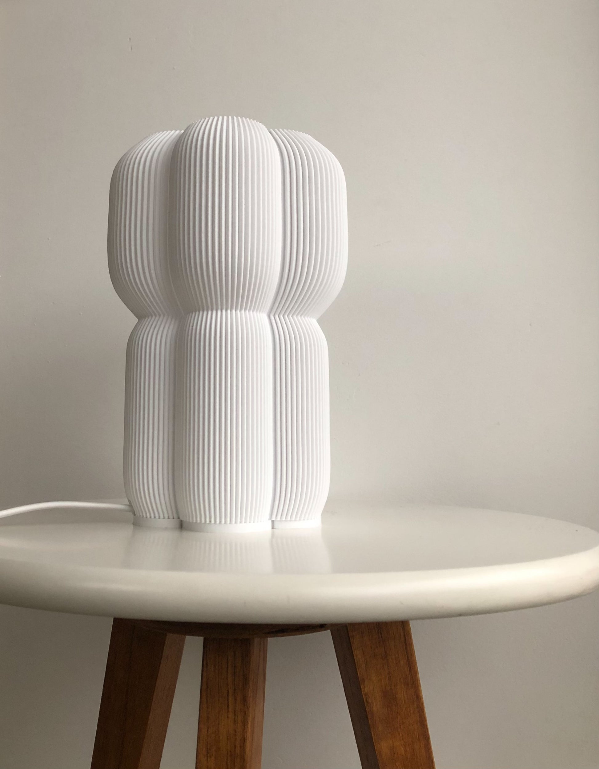 a white sculpture sitting on top of a white table