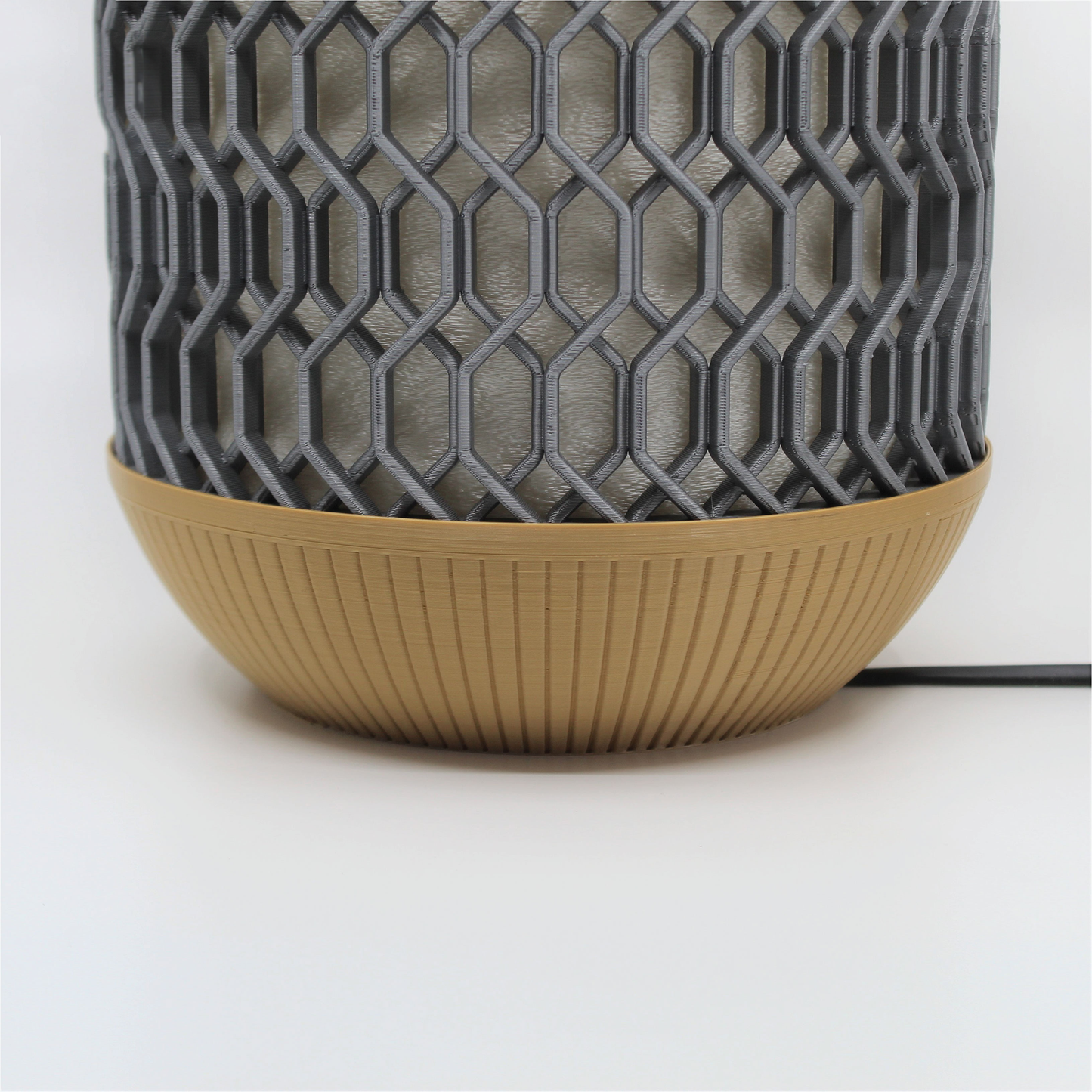 a gray and brown vase sitting on top of a table