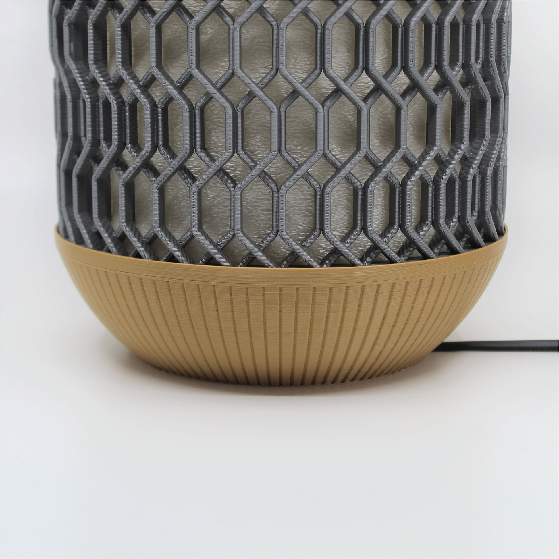 a gray and brown vase sitting on top of a table