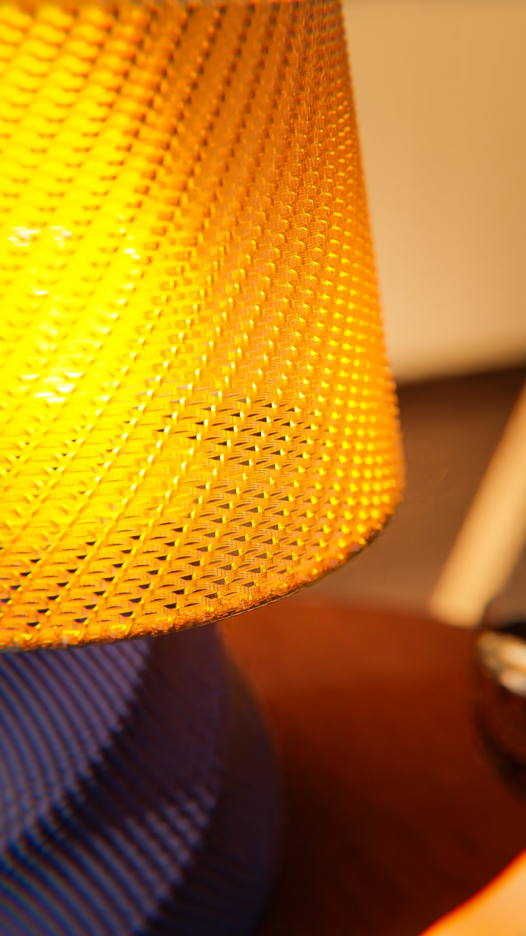 a yellow lamp sitting on top of a wooden table