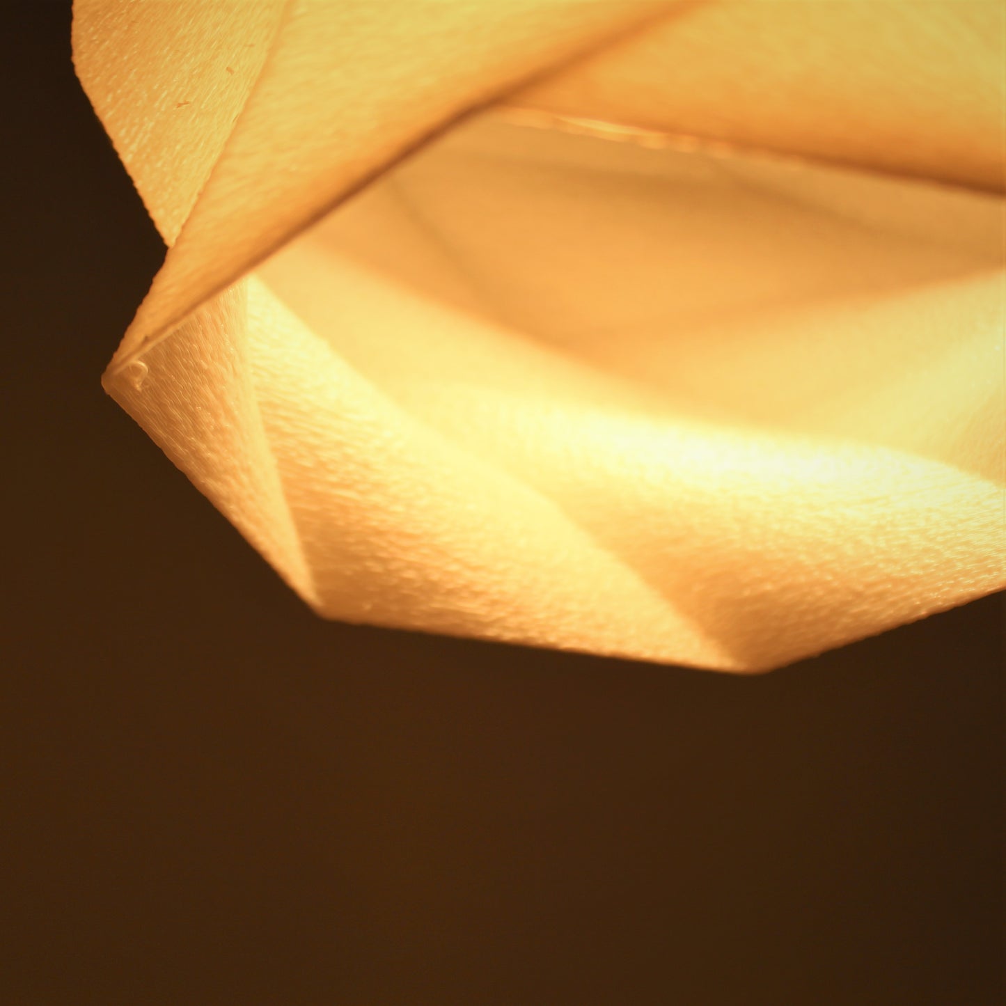 a close up of a paper lantern on a table