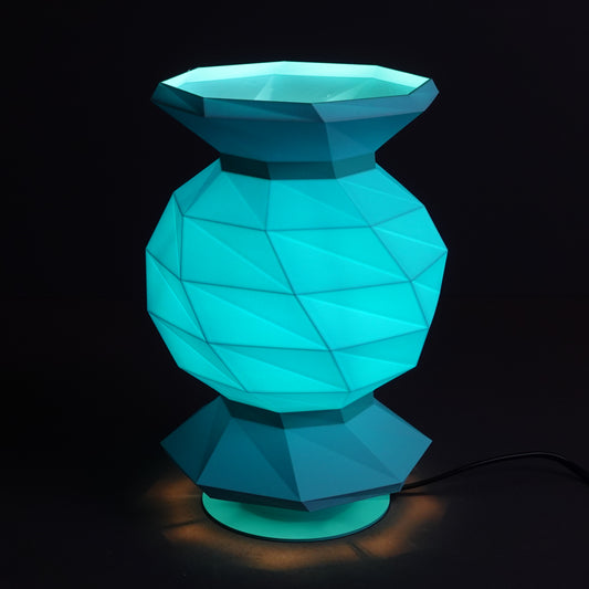 a blue vase sitting on top of a table